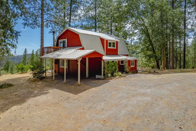 a view of a house with a yard and sitting area