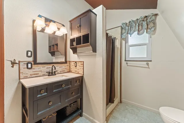a bathroom with a sink a mirror and a toilet