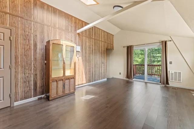 a view of a house with wooden floor and entryway