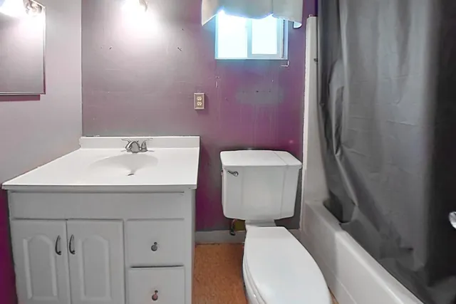 a white toilet sitting next to a bathroom sink