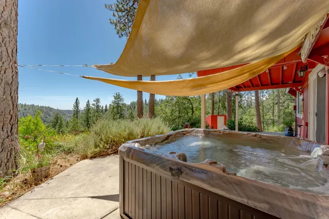 a view of a backyard with table and chairs under an umbrella