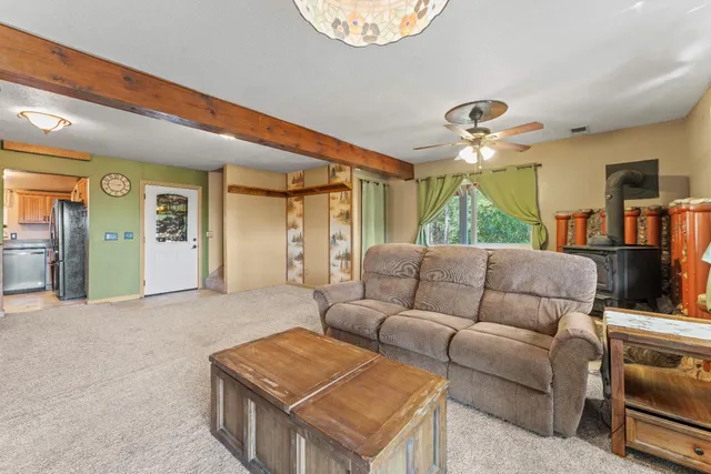 a living room with furniture and a chandelier