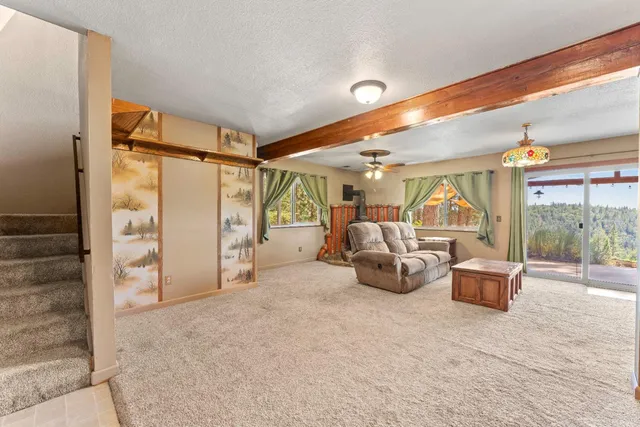 a bedroom with furniture and a large window