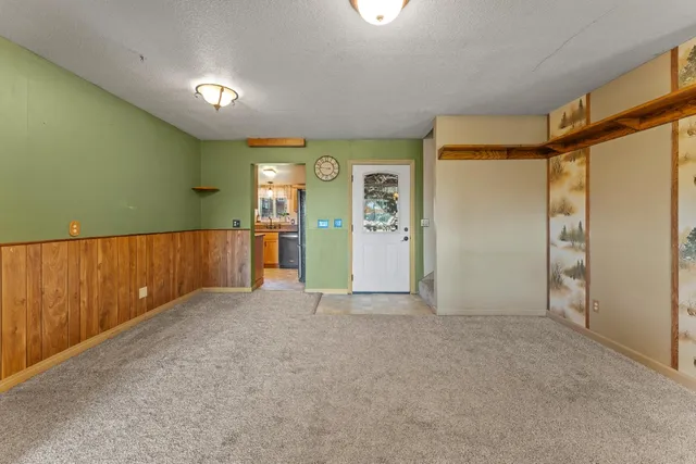 an empty room with closet and wooden door