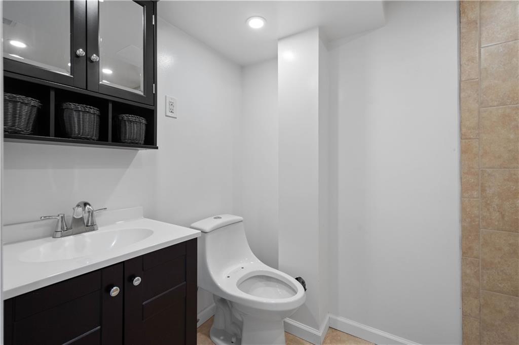 215 Pinchtown Road Pittsburgh, PA 15236 - Photo 20 of 31 a bathroom with a toilet a sink and mirror