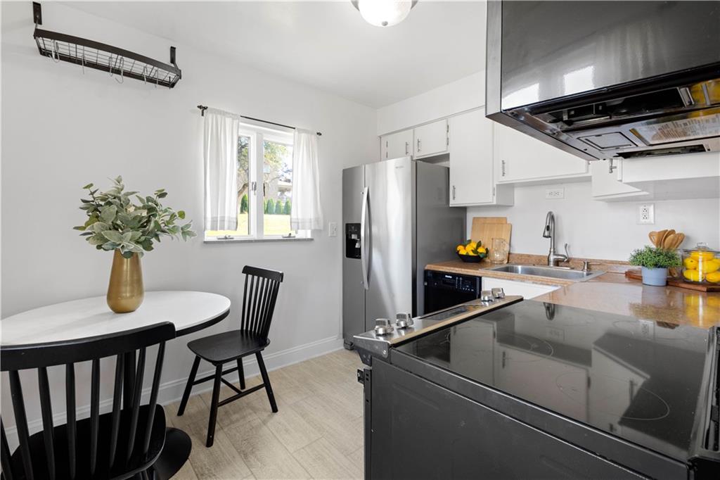 215 Pinchtown Road Pittsburgh, PA 15236 - Photo 3 of 31 a open kitchen with stainless steel appliances granite countertop a sink refrigerator dining table and chairs