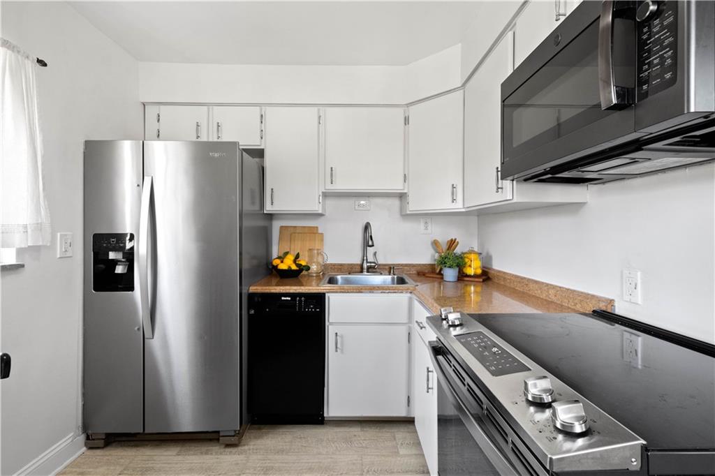 215 Pinchtown Road Pittsburgh, PA 15236 - Photo 4 of 31 a kitchen with a refrigerator stove and cabinets