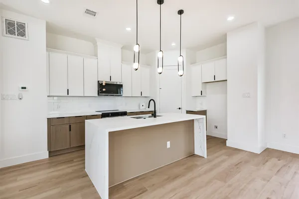 a view of kitchen with sink microwave and stove