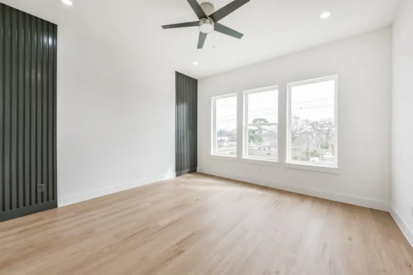 a kitchen with stainless steel appliances granite countertop a sink a stove and a wooden floors