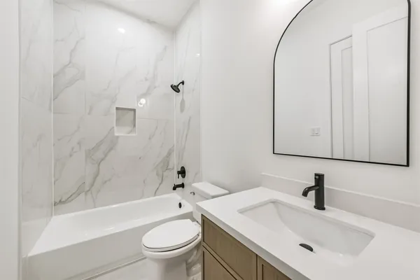 a bathroom with a sink a toilet and a bathtub