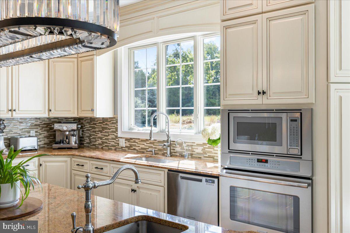 29 Tumble Falls Road Stockton, NJ 08559 - Photo 16 of 78 a kitchen with granite countertop a sink stainless steel appliances a counter top space and cabinets