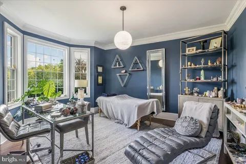 a bedroom with a large bed and a flat screen tv