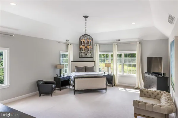 a bedroom with a large bed and a book shelf
