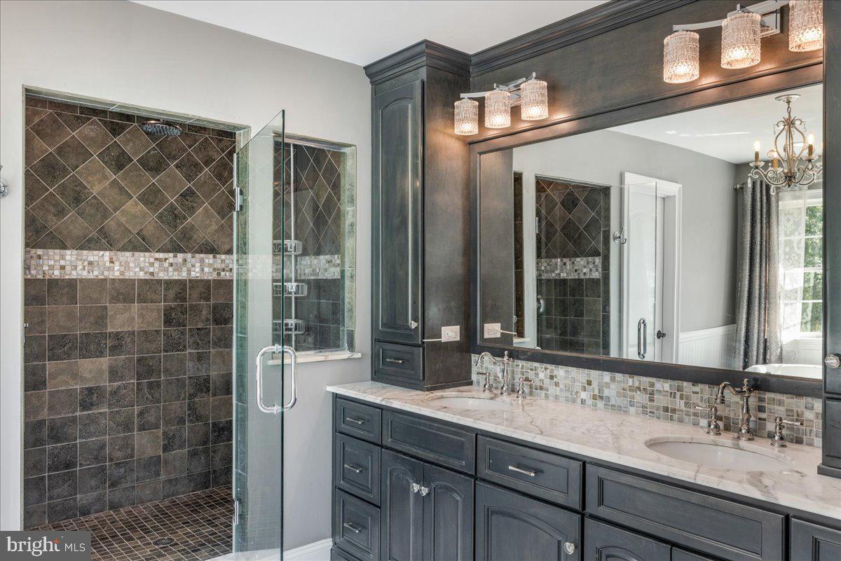 29 Tumble Falls Road Stockton, NJ 08559 - Photo 33 of 78 a bathroom with a double vanity sink mirror and shower