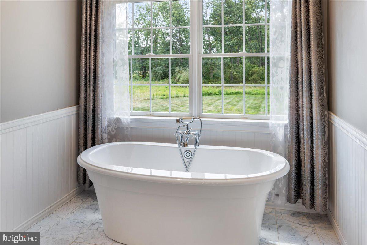 29 Tumble Falls Road Stockton, NJ 08559 - Photo 35 of 78 a white bath tub sitting in a bathroom next to a window