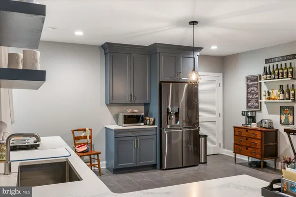 a kitchen with a sink cabinets and wooden floor