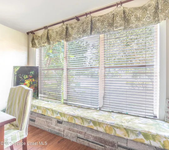 a dining room with furniture and window