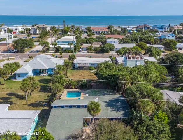 an aerial view of residential houses with outdoor space