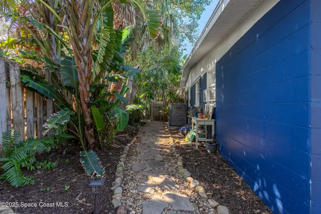 a view of a patio with table and chairs potted plants