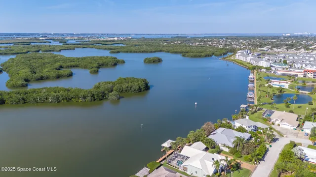 an aerial view of residential houses with outdoor space and lake view