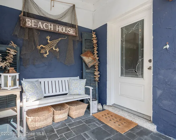 a front view of house with a garden and patio