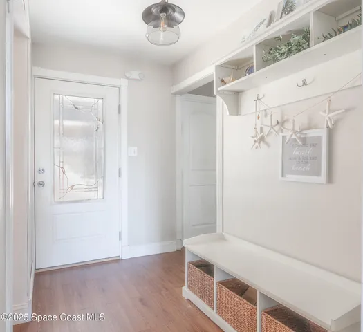a living room with furniture fireplace and a large window