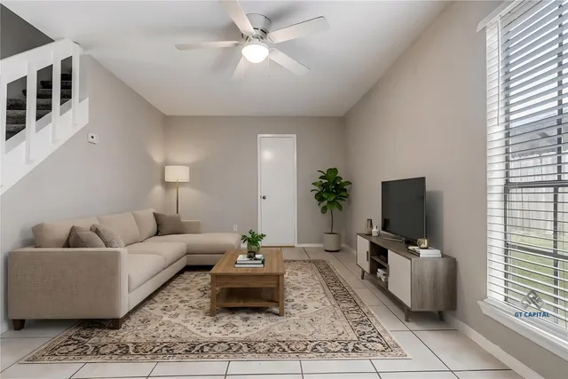 a living room with furniture and a flat screen tv