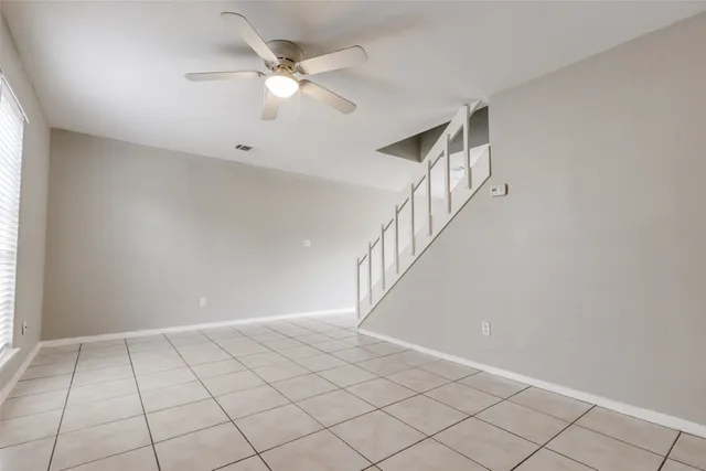 a bedroom with a bed a couch and potted plant with the dresser