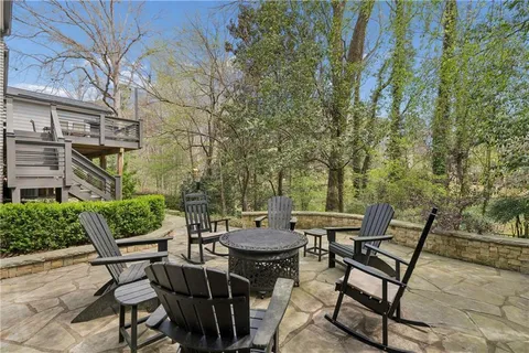 a backyard of a house with table and chairs