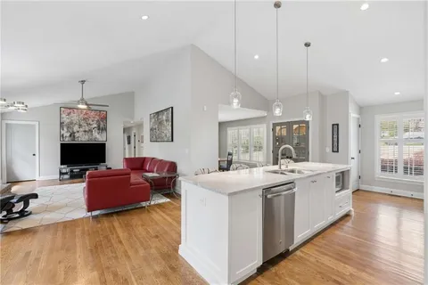 a large white kitchen with a large window