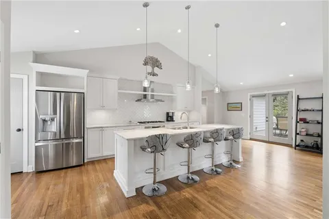a large kitchen with a table and chairs