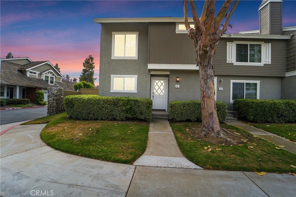 51 Misty Run, Unit 11 Irvine, CA 92614 - Photo 1 of 1 a view of a brick house with a yard
