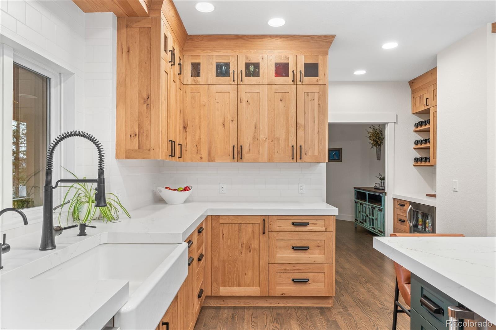 1735 Prima Lane Evergreen, CO 80439 - Photo 11 of 50 a kitchen with a refrigerator and a stove top oven