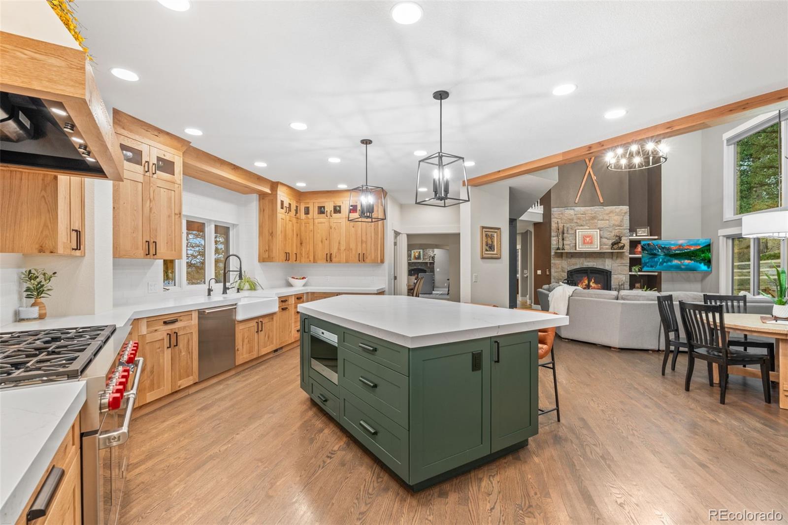 1735 Prima Lane Evergreen, CO 80439 - Photo 12 of 50 a kitchen that has a lot of cabinets in it and wooden floors