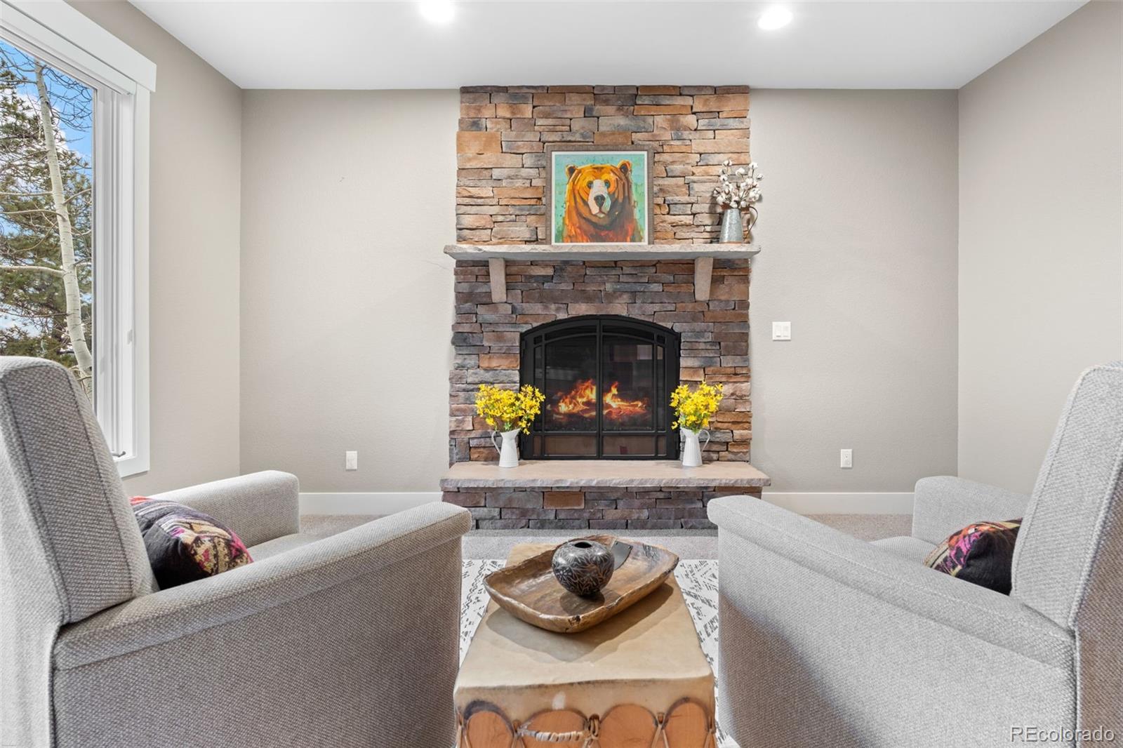 1735 Prima Lane Evergreen, CO 80439 - Photo 16 of 50 a living room with furniture and a fireplace