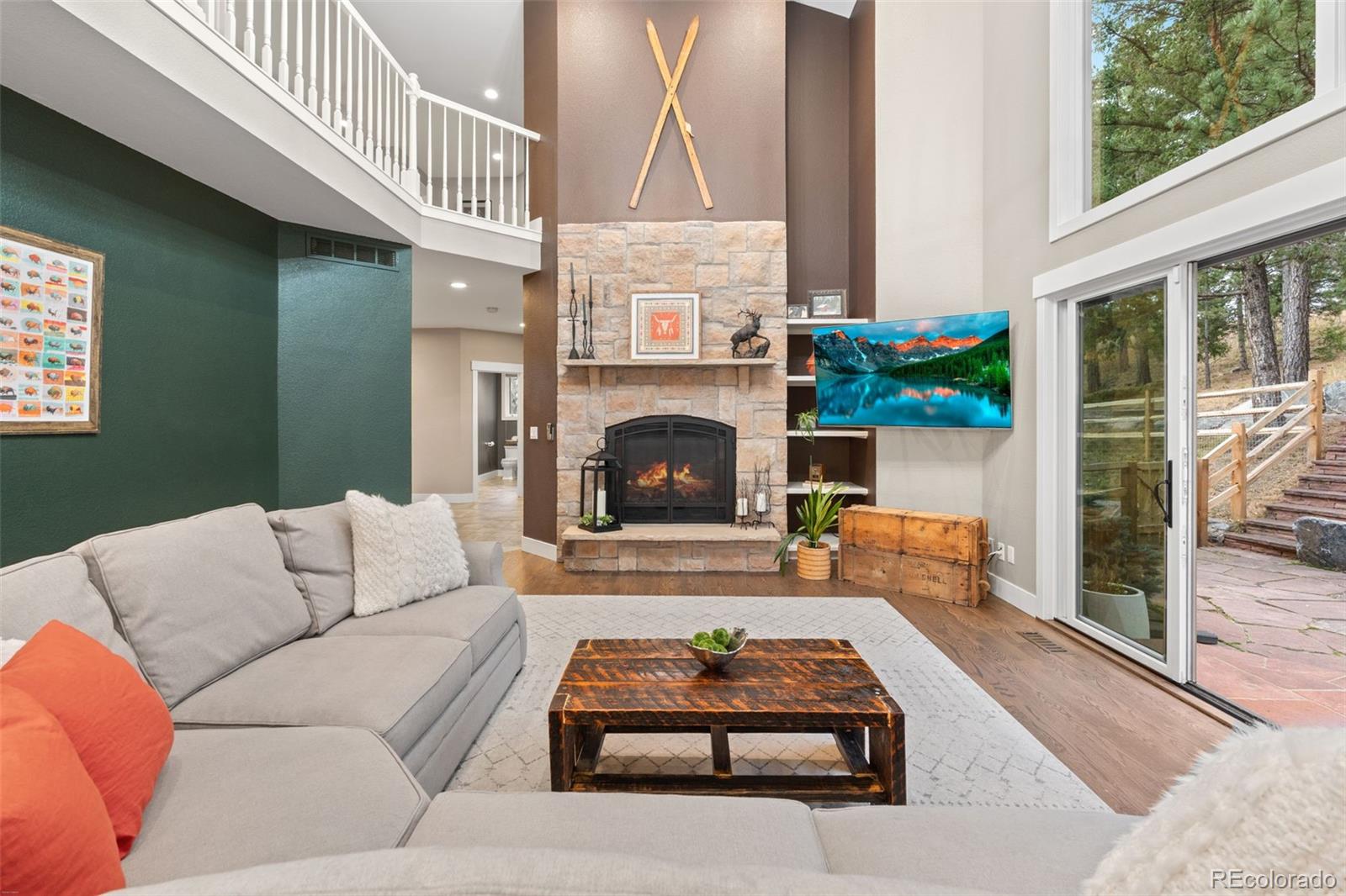 1735 Prima Lane Evergreen, CO 80439 - Photo 22 of 50 a living room with furniture and a fireplace
