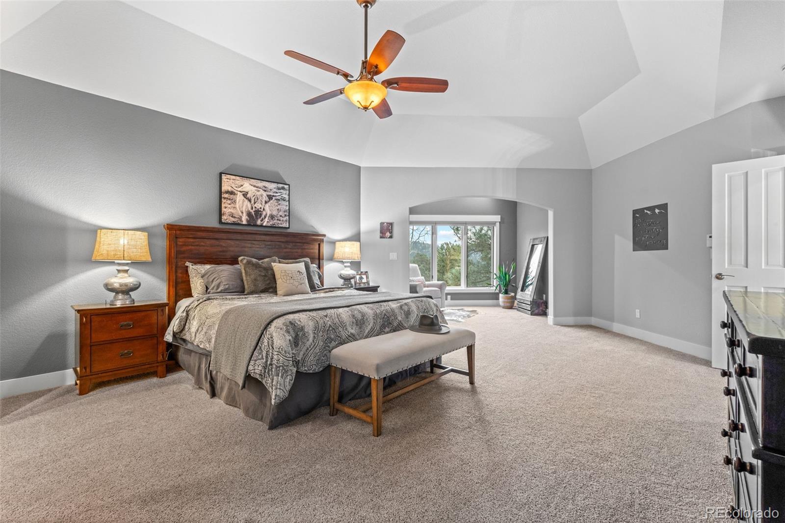 1735 Prima Lane Evergreen, CO 80439 - Photo 3 of 50 a bedroom with a bed and a large window