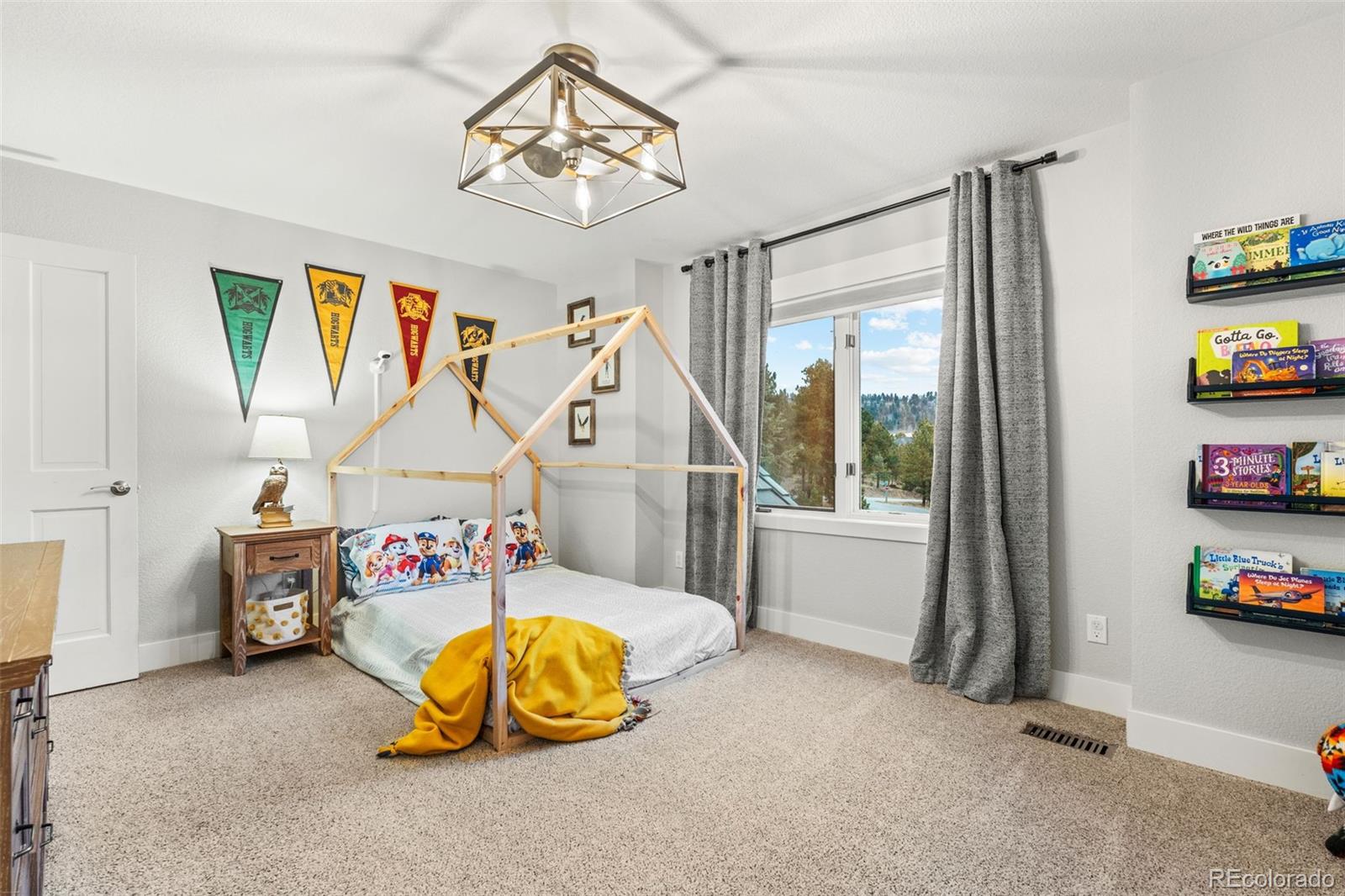 1735 Prima Lane Evergreen, CO 80439 - Photo 32 of 50 a view of a room with toys and a chandelier