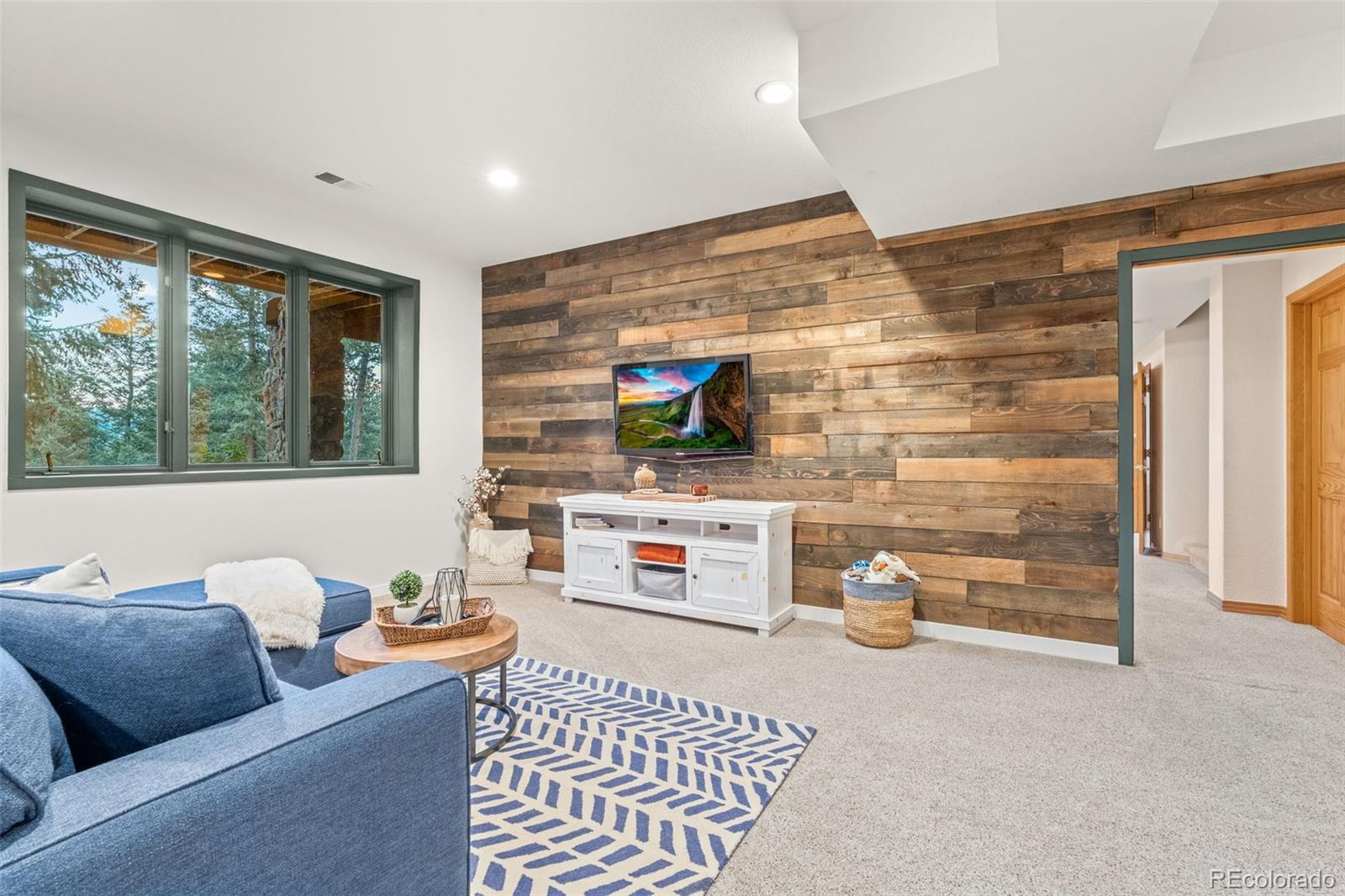 1735 Prima Lane Evergreen, CO 80439 - Photo 36 of 50 a living room with furniture and a flat screen tv