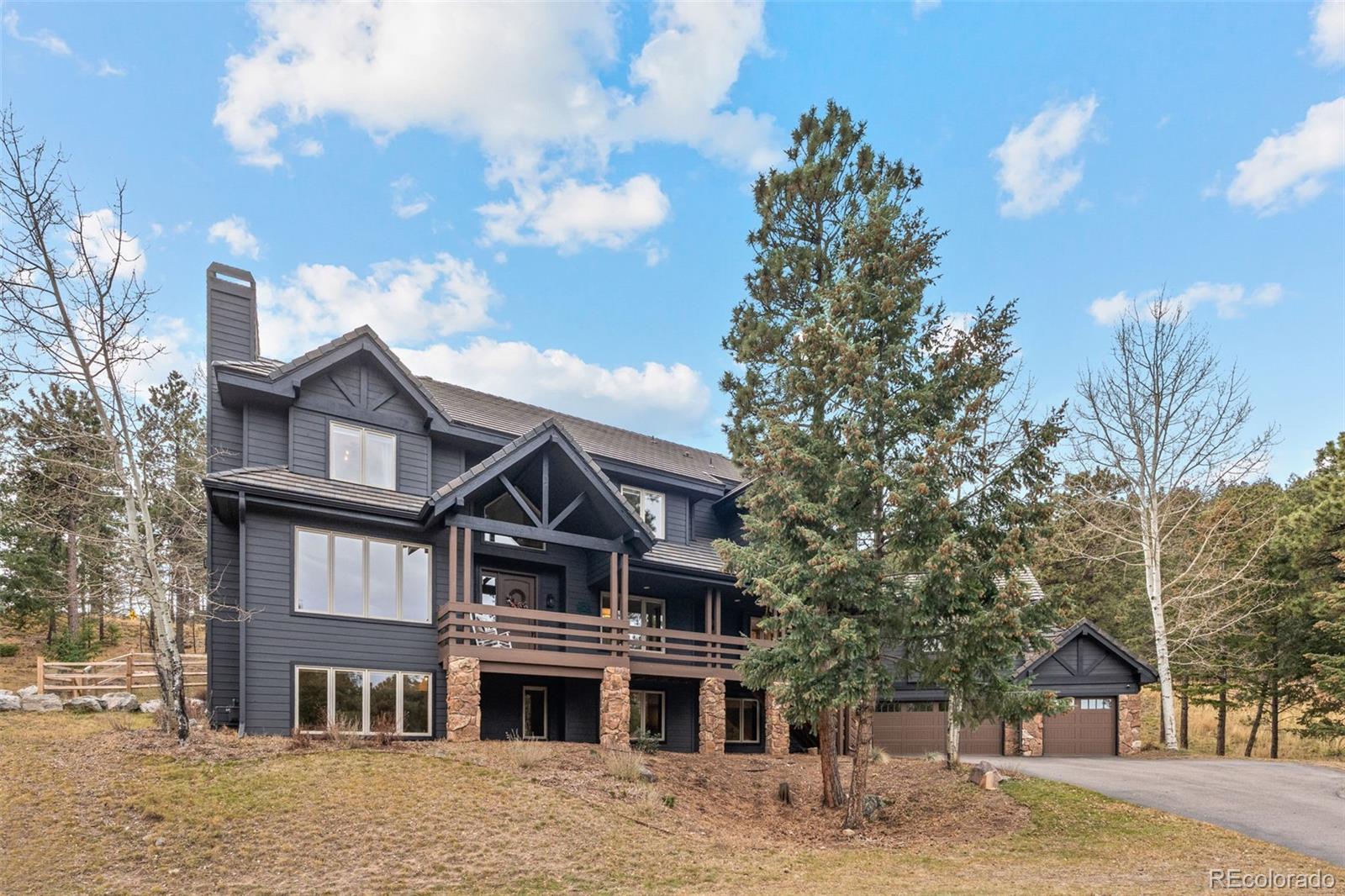1735 Prima Lane Evergreen, CO 80439 - Photo 45 of 50 a front view of a residential apartment building with a yard