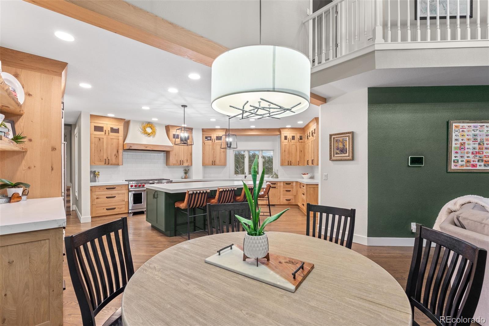 1735 Prima Lane Evergreen, CO 80439 - Photo 8 of 50 a dining room with furniture a kitchen view and a chandelier