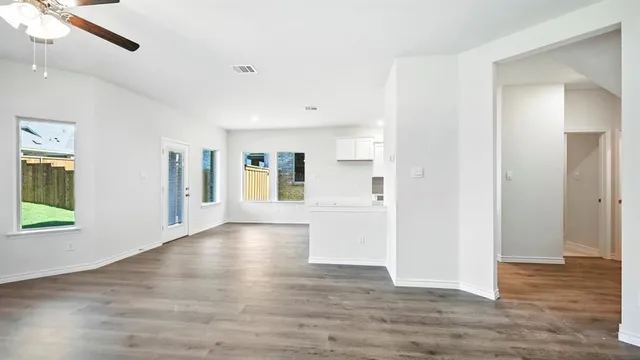 a kitchen with white cabinets and black appliances