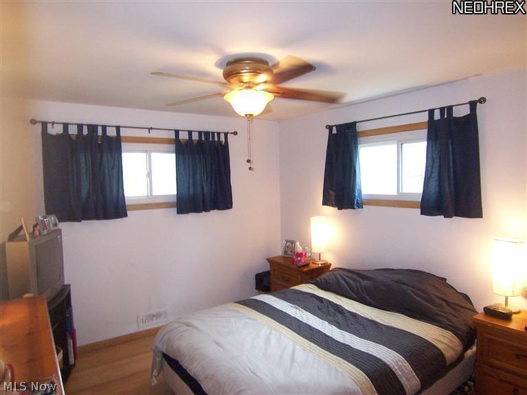 10212 Biddulph Road Cleveland, OH 44144 - Photo 13 of 20 Master bedroom with hardwood floor & ceiling fan. All bedrooms have large closets.