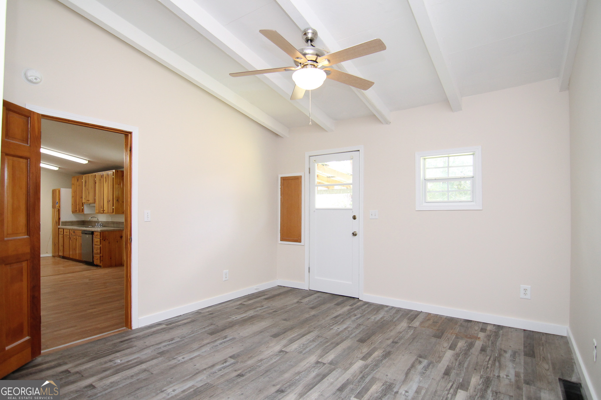 48 Forest Avenue Butler, GA 31006 - Photo 11 of 21 an empty room with wooden floor and ceiling fan