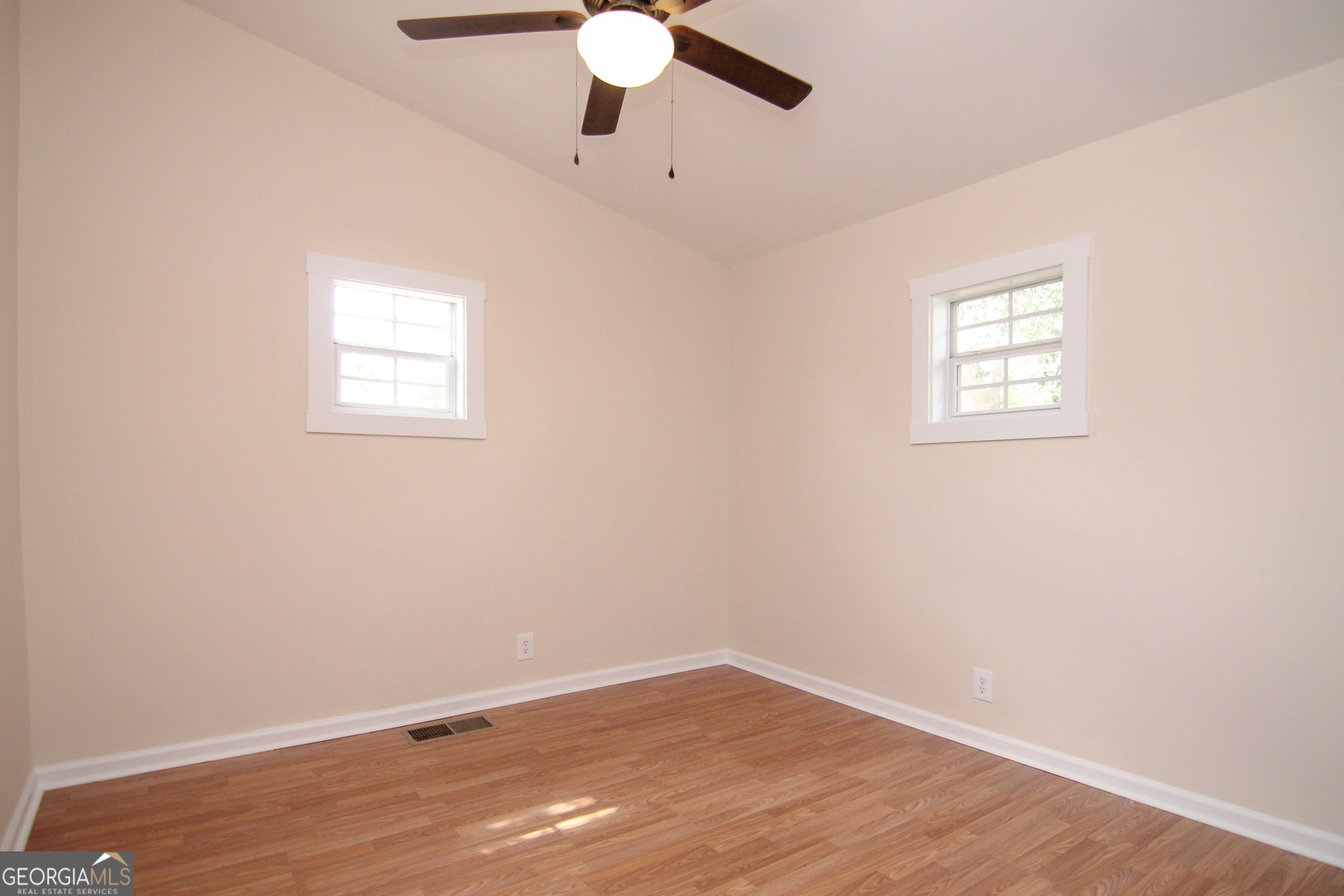 48 Forest Avenue Butler, GA 31006 - Photo 17 of 21 an empty room with a window and a ceiling fan