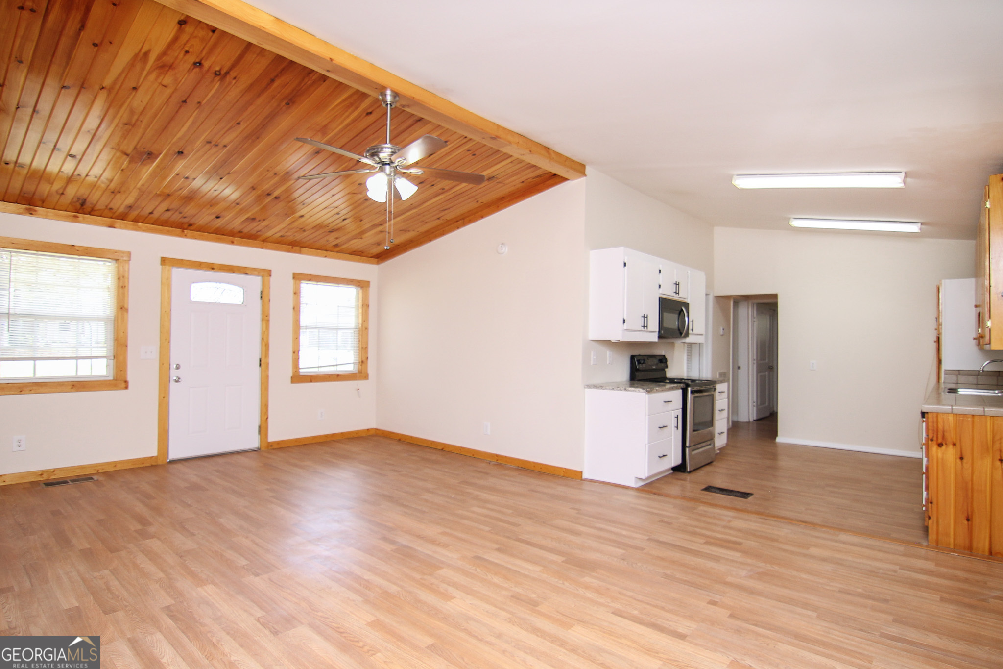 48 Forest Avenue Butler, GA 31006 - Photo 4 of 21 a view of empty room with wooden floor and ceiling fan