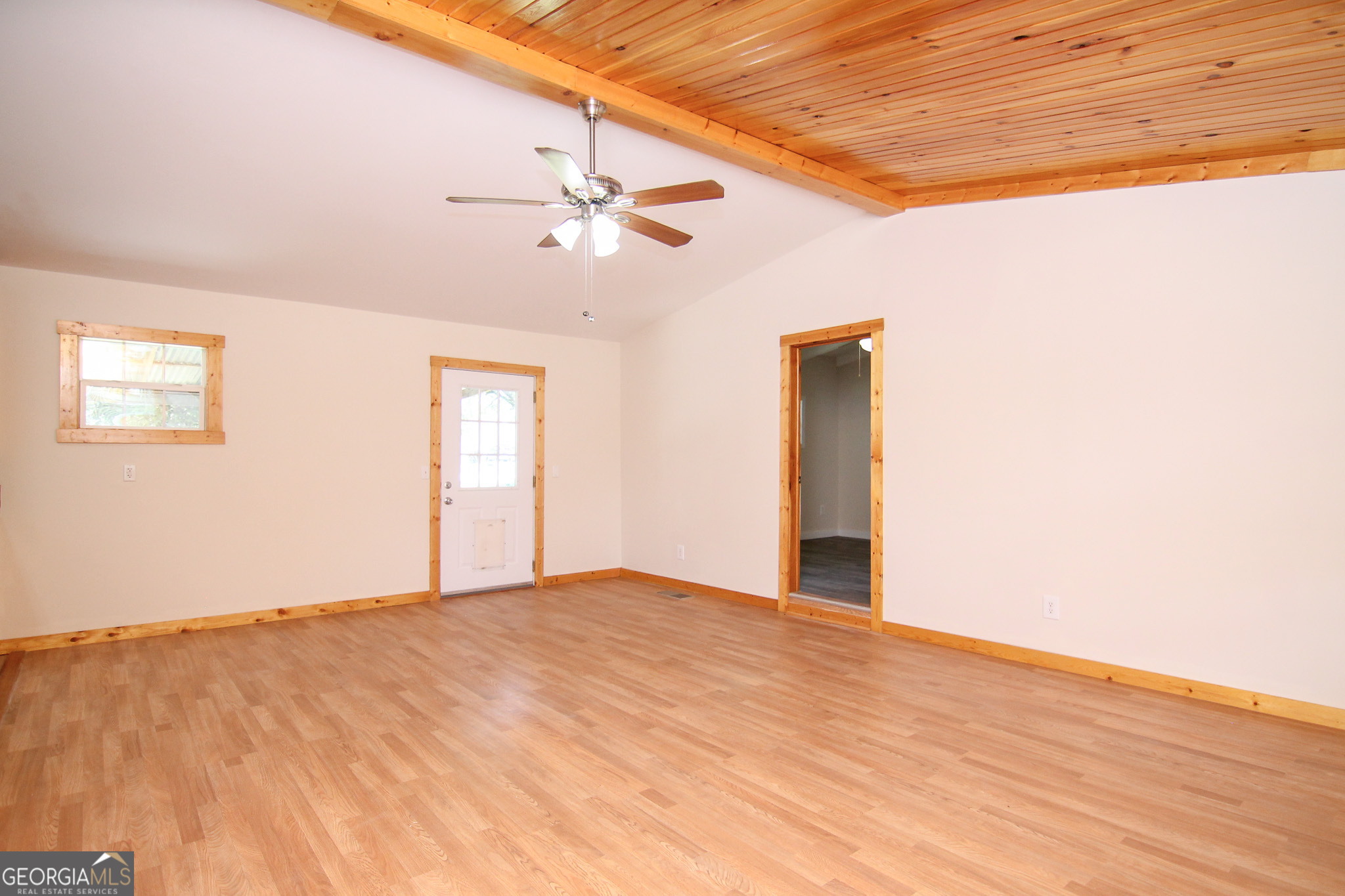 48 Forest Avenue Butler, GA 31006 - Photo 5 of 21 a view of an empty room with wooden floor and a ceiling fan