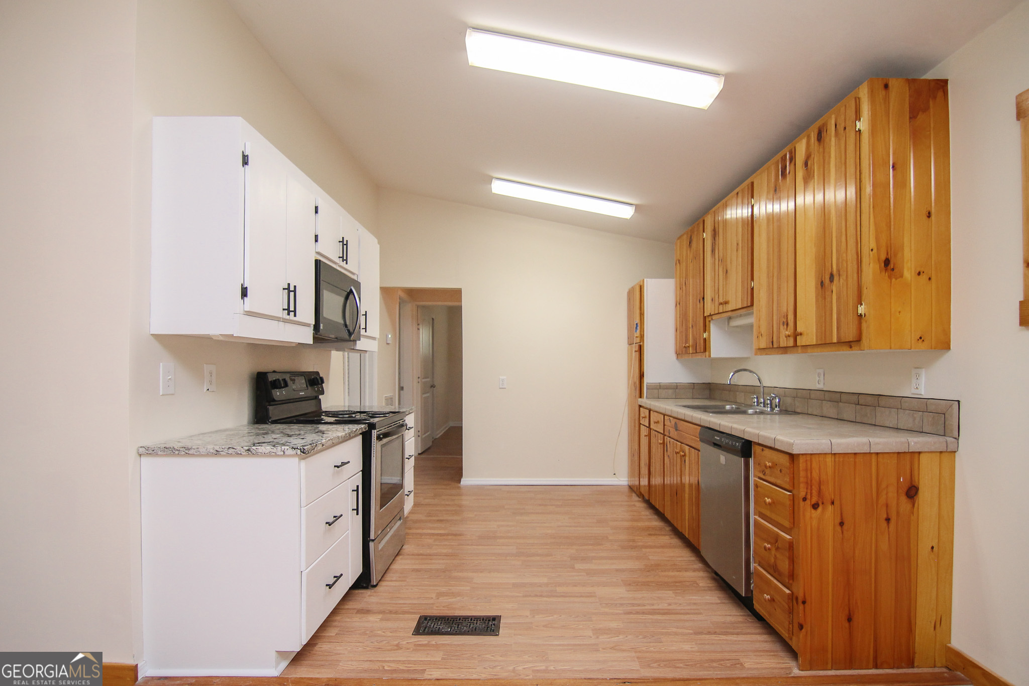 48 Forest Avenue Butler, GA 31006 - Photo 6 of 21 a kitchen with stainless steel appliances granite countertop a stove a sink and a refrigerator