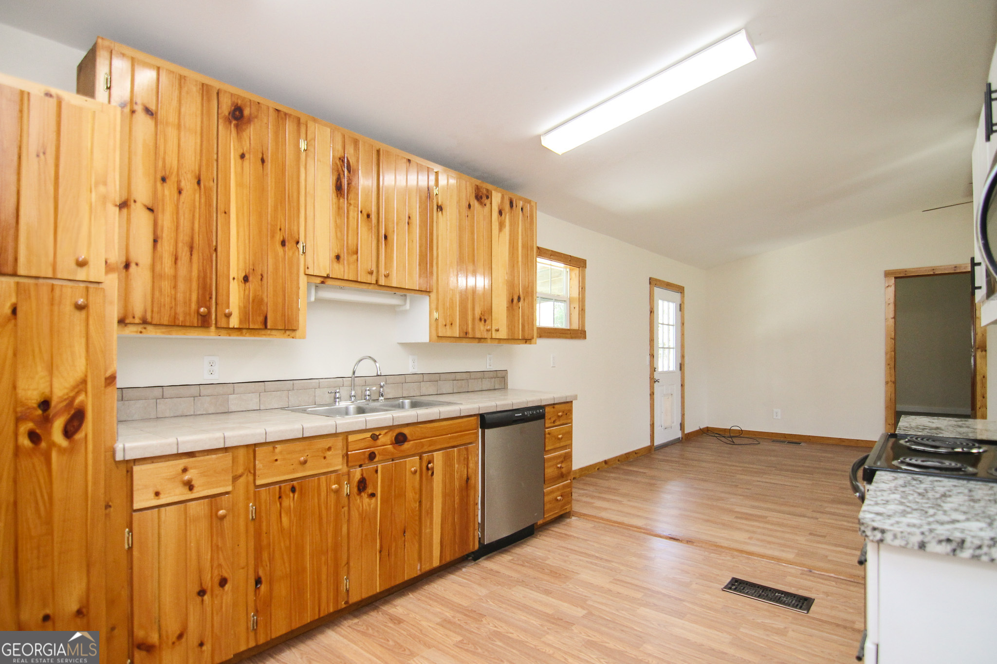 48 Forest Avenue Butler, GA 31006 - Photo 8 of 21 a kitchen with a sink cabinets and wooden floor