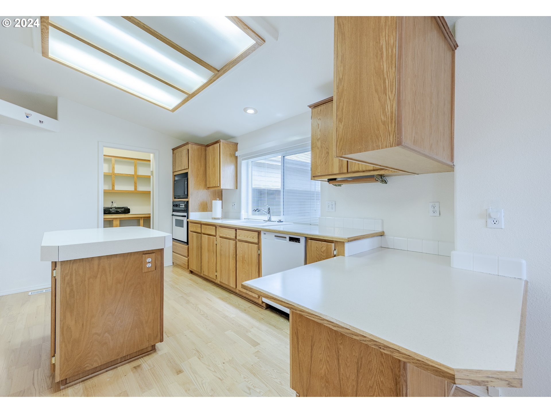 3220 Crescent Avenue, Unit 67 Eugene, OR 97408 - Photo 24 of 48 a kitchen with a sink cabinets stainless steel appliances and a counter top space